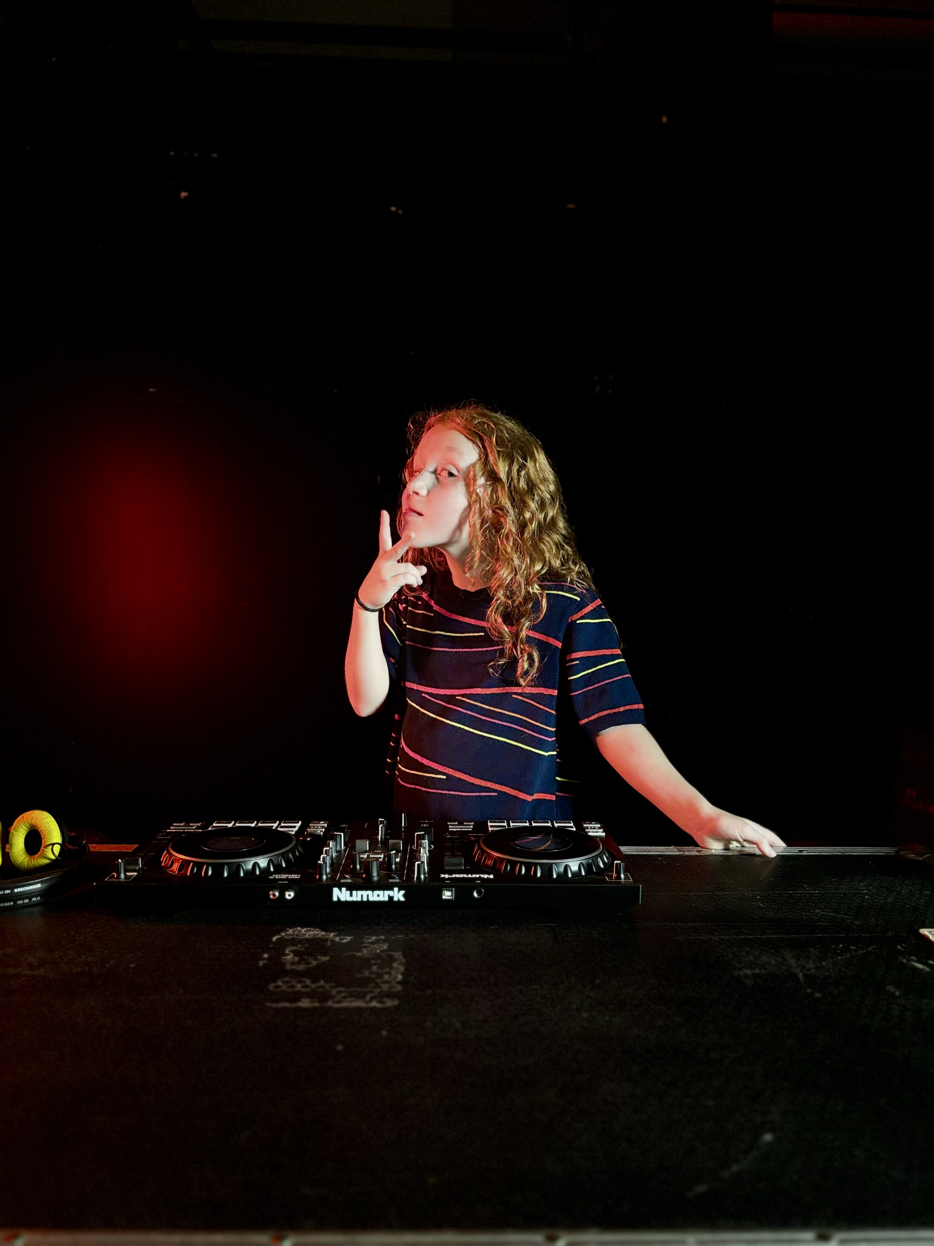 A young producer mixing a session at the studio console