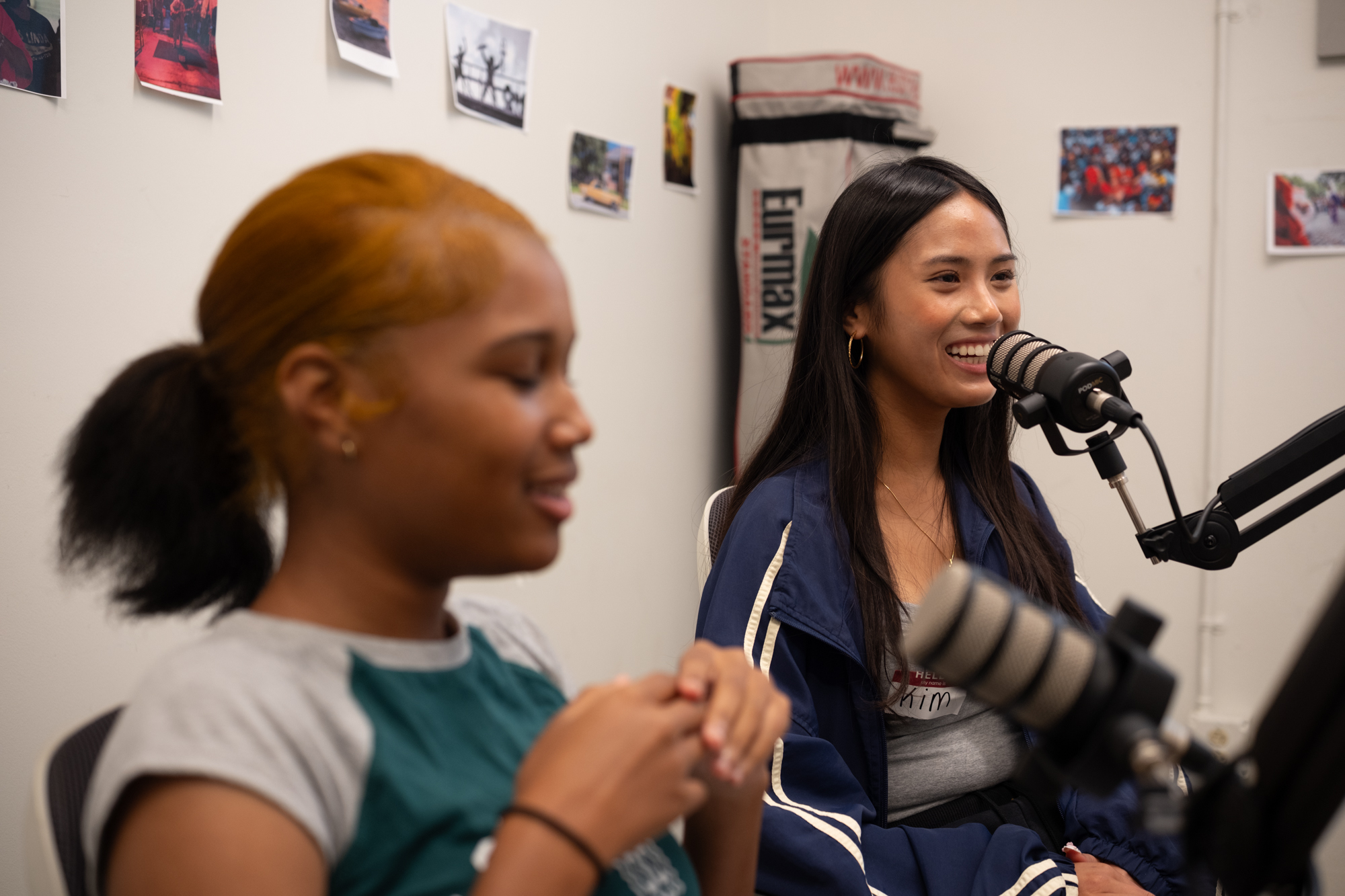 Two young women recording a podcast together at a Be Loud session